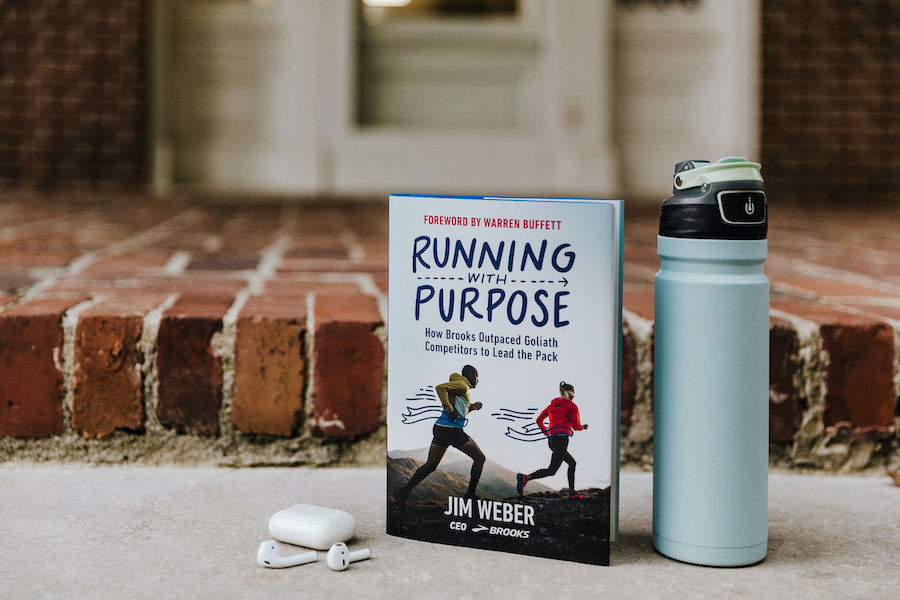 Running with Purpose next to a water bottle and earbuds